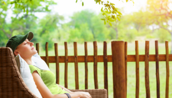 A woman relaxing in a comfortable chair at a luxury drug rehab center